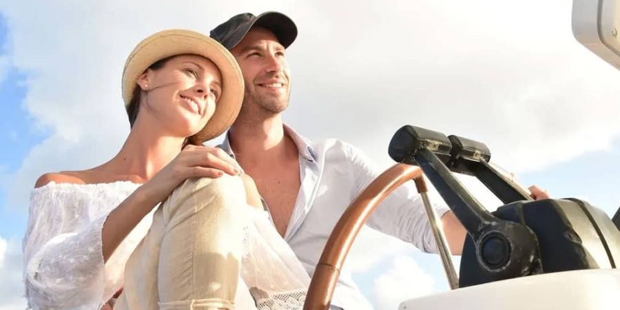 Couple enjoying boat rental in the Hamptons Couple enjoying boat rental in the Hamptons